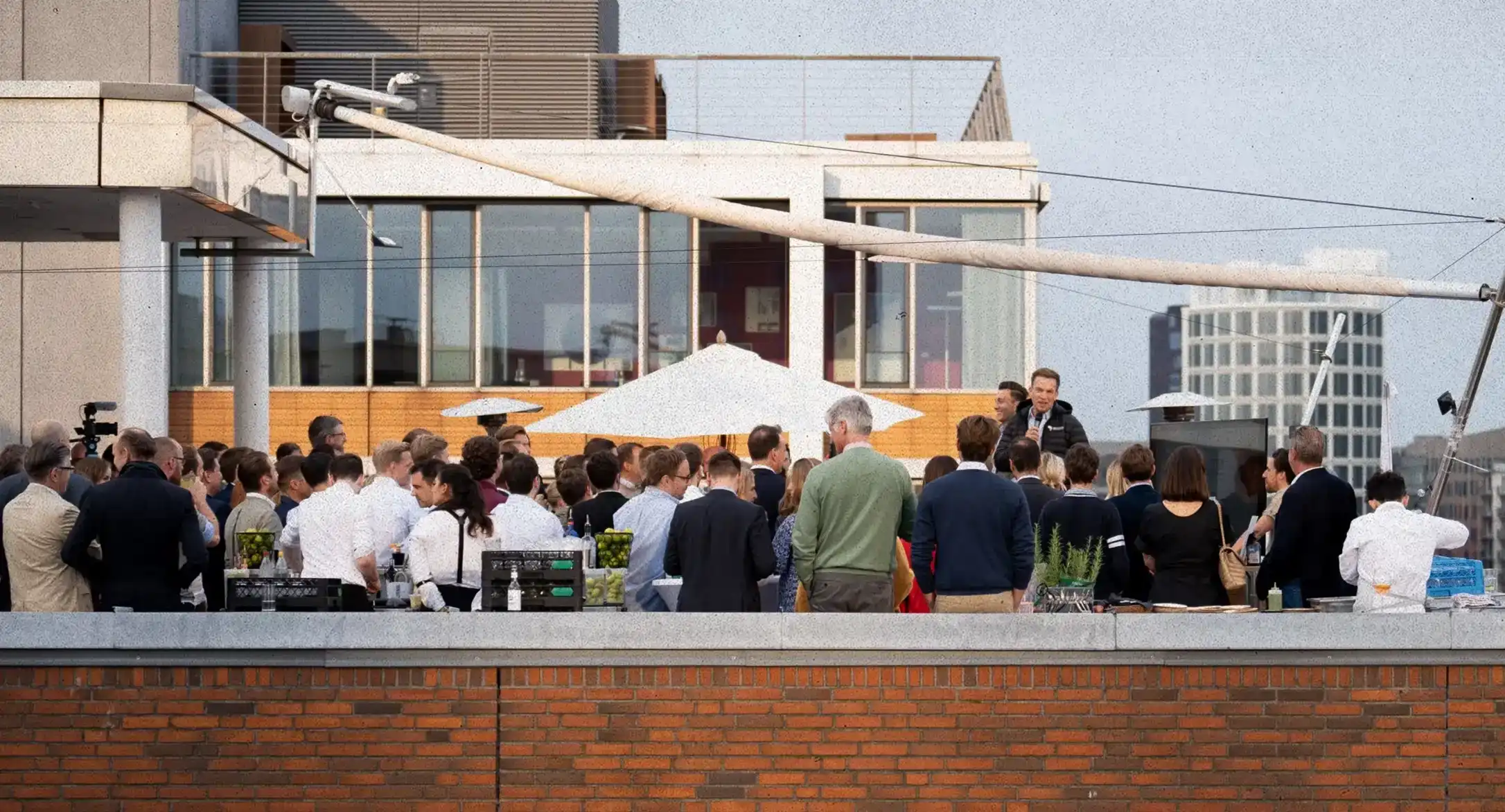 Event audience on roof terrace at a speech by the AMES founders